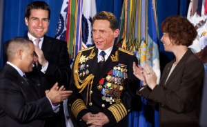 The Honorable, the Beneficent, Fleet Admiral David Miscavige is applauded by Sea Org members including Tom Cruise. 